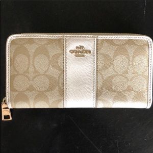 Tan and white Coach wallet